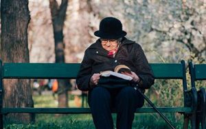 Resident Reading Book on bench