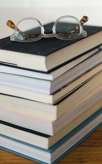 Glasses on Pile of Books