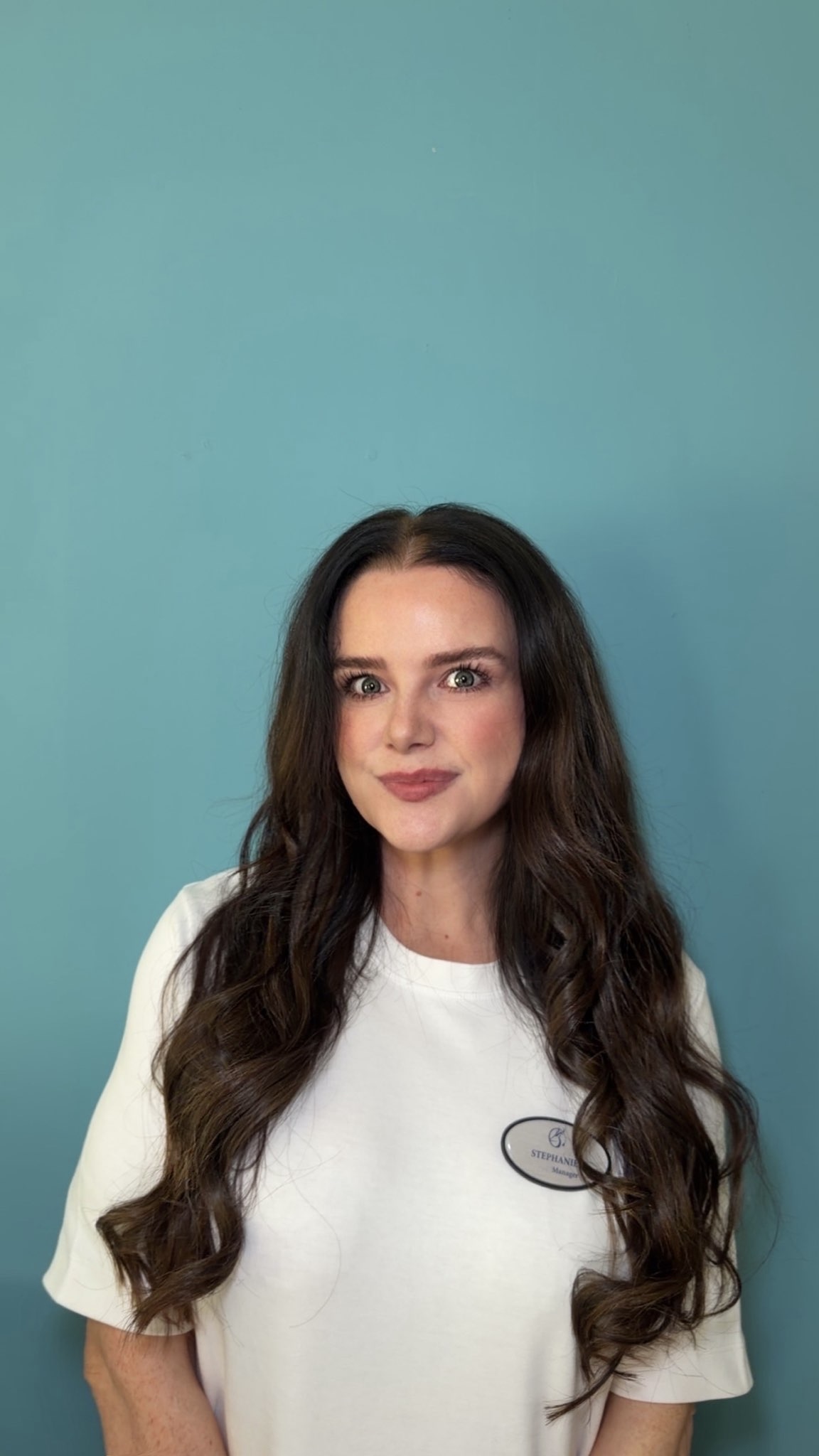 lady with long hair posing for staff photo