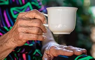 Old Lady Holding Cup of Tea