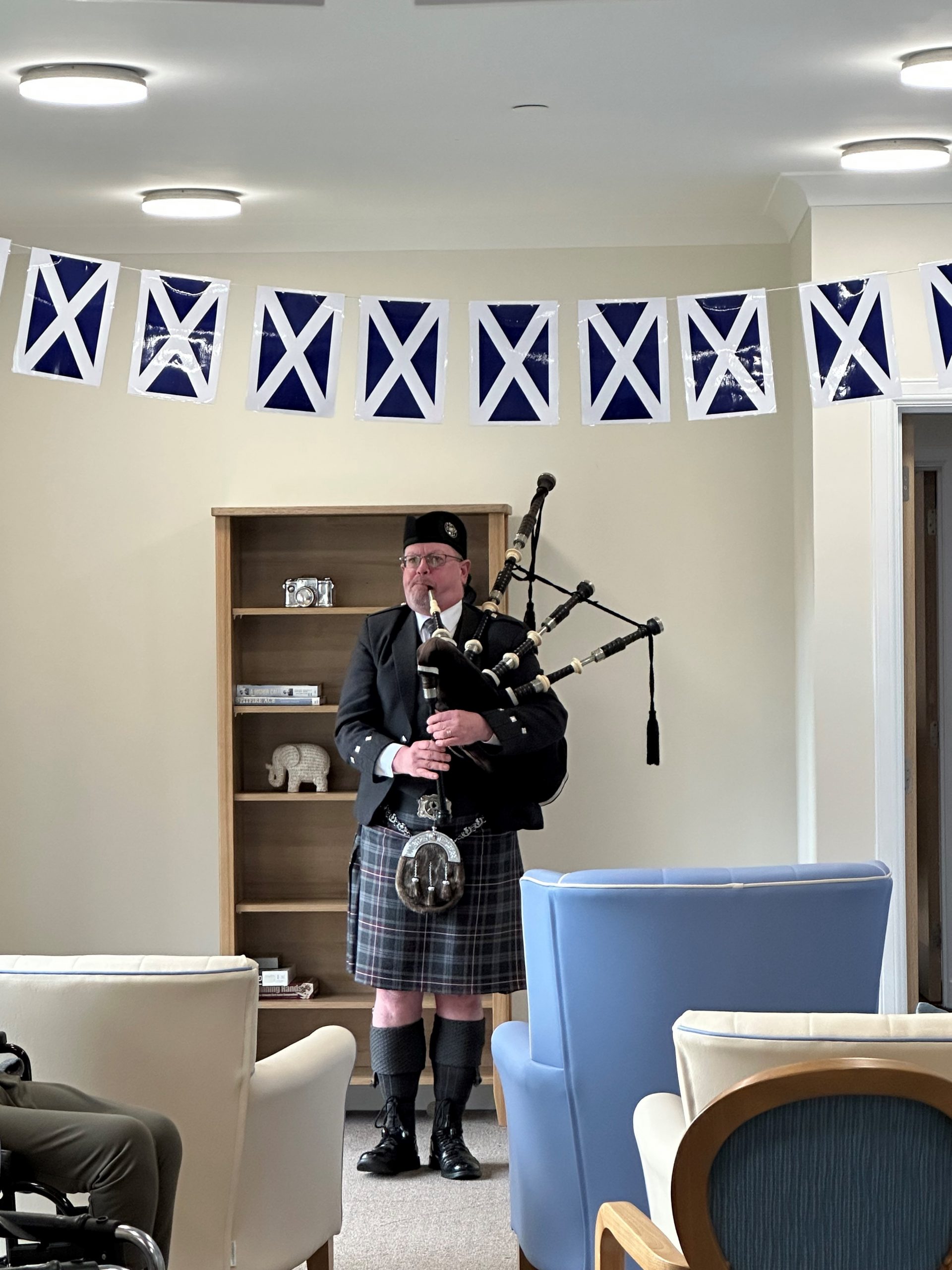 Entertainer Playing the Bagpipes for Care Home Residents