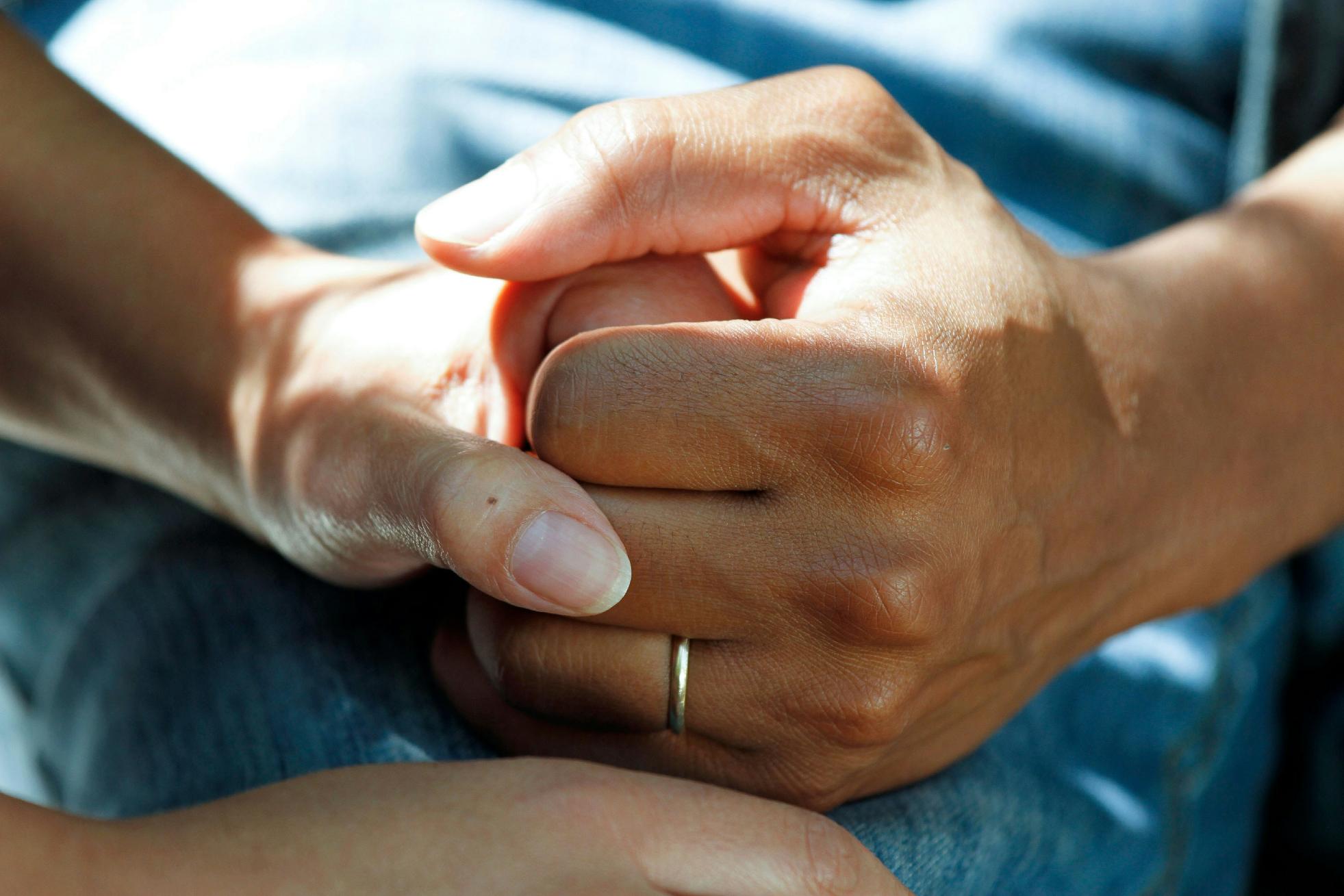 holding hands to reassure resident