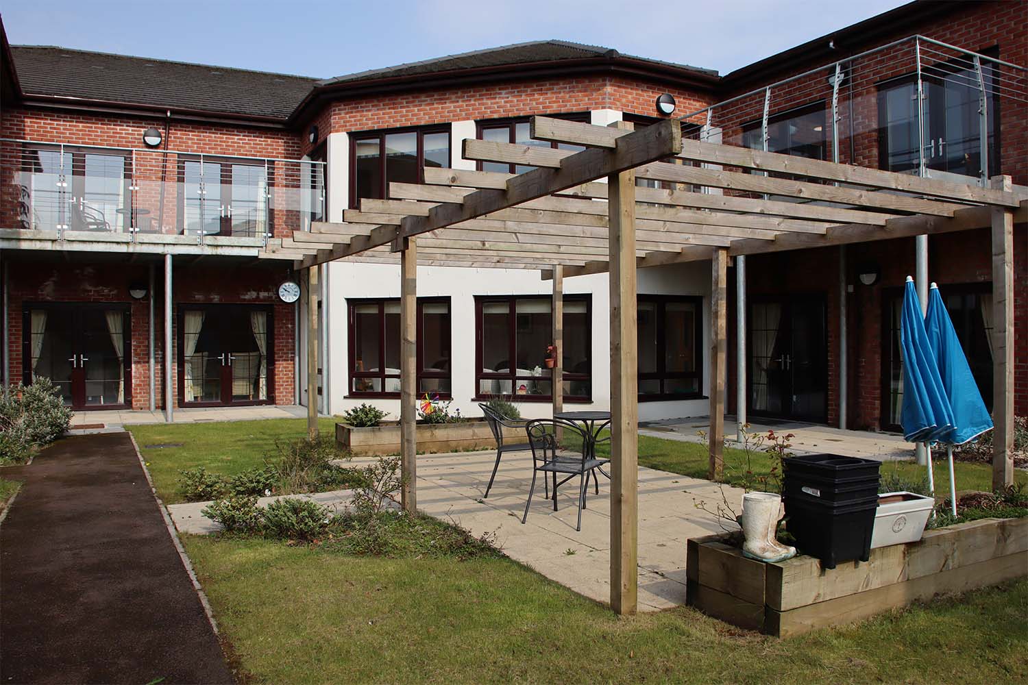 care home garden with pergola and patio furniture