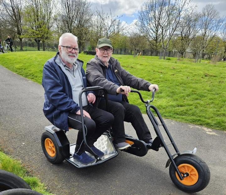 two older men on a bike
